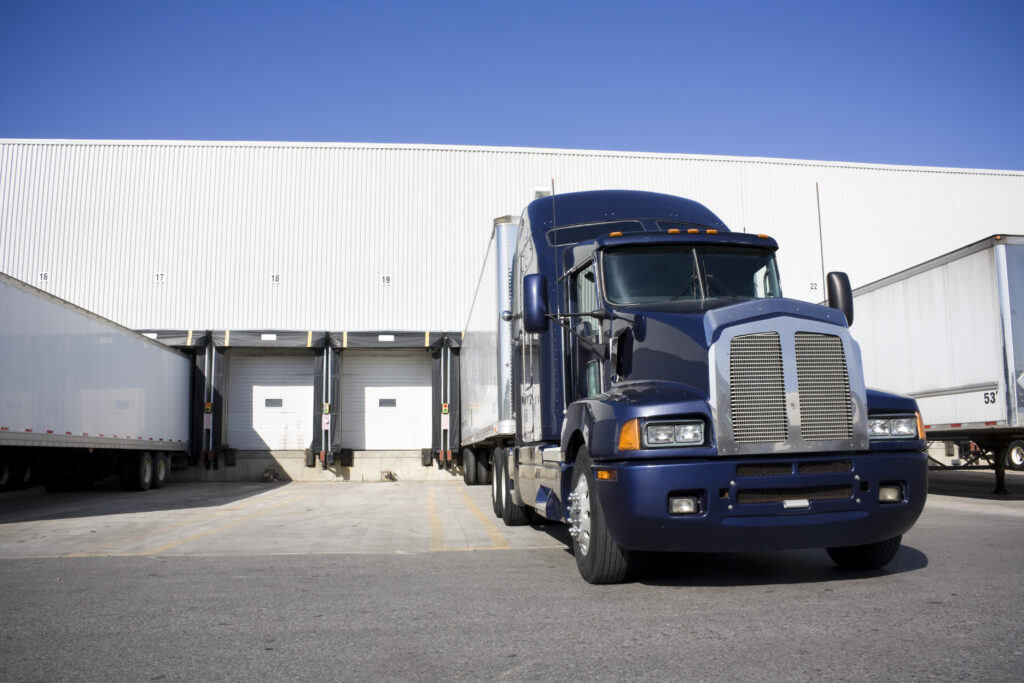 Blue Transport Truck Docking in warehouse